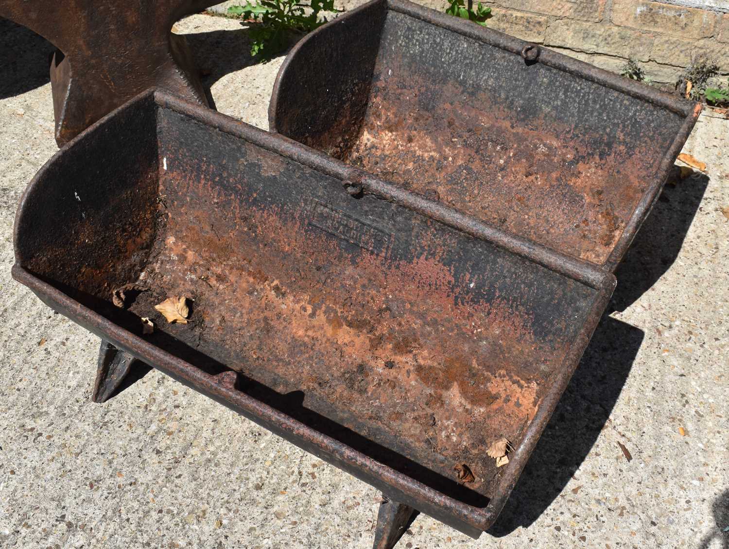 Lot 518 - Two cast iron pig troughs, one example made by...