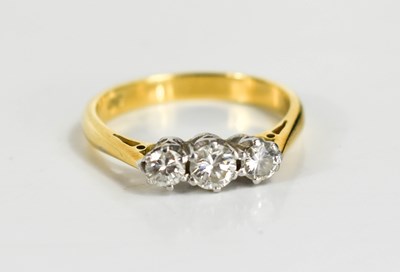 Lot 139 - An 18ct gold and diamond three stone ring, the...