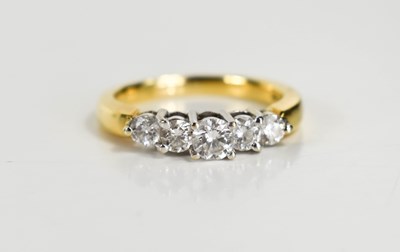 Lot 271 - An 18ct gold and diamond five stone ring, the...