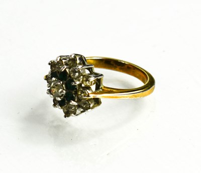 Lot 114 - A dress ring in diamond and emerald cluster...