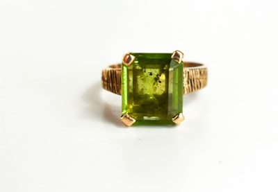 Lot 73 - A 9ct gold and peridot dress ring, the large...