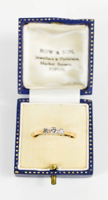 Lot 127 - An 18ct gold and diamond three stone ring, the...