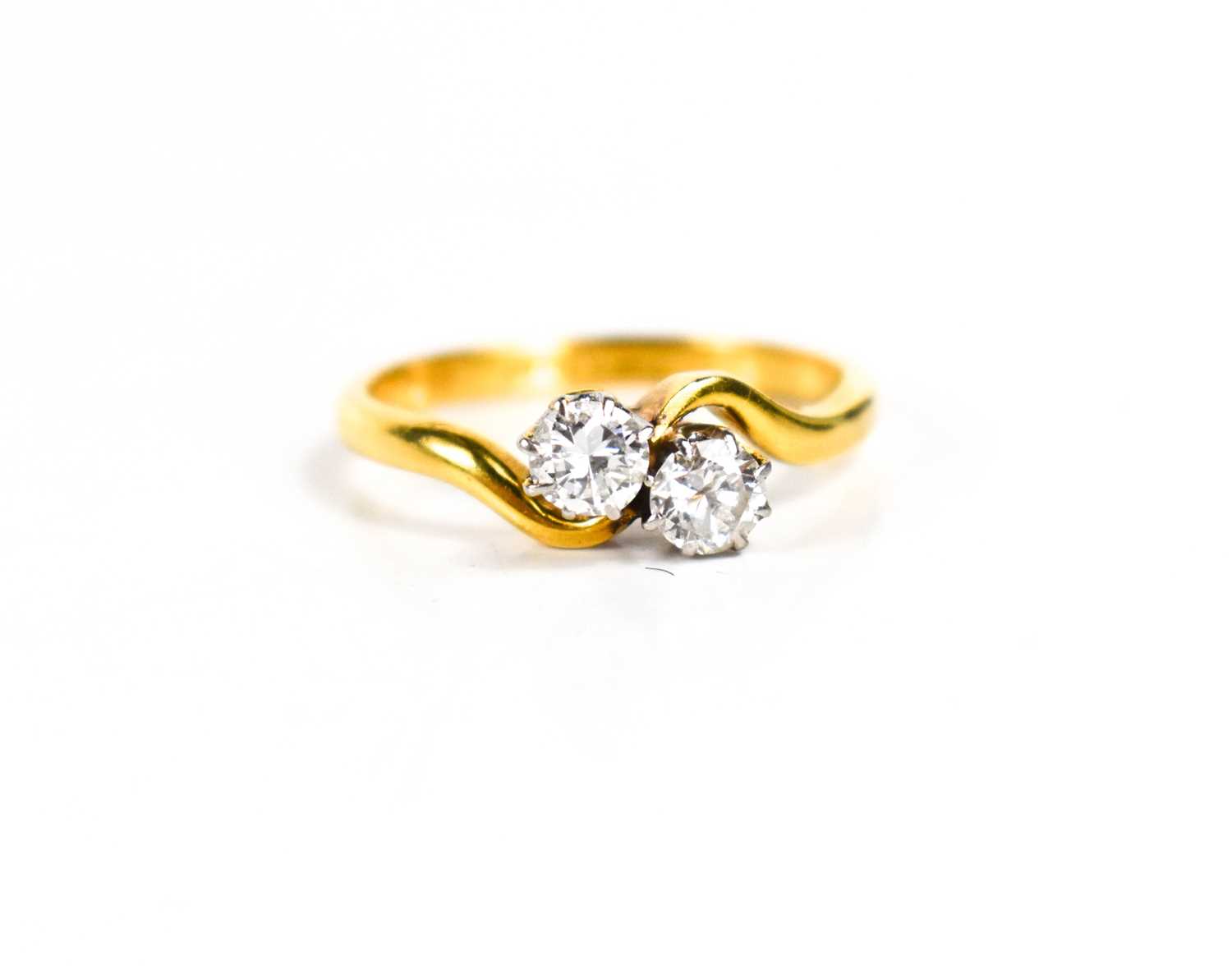 Lot 272 - An 18ct gold and diamond crossover ring, each...