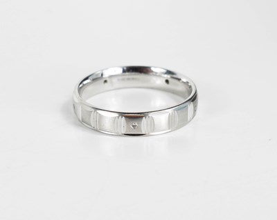 Lot 160 - A 9ct white gold wedding band, the textured...