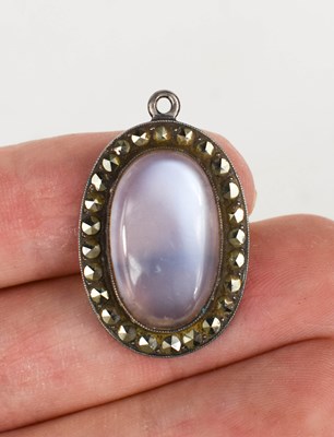 Lot 44 - A silver, marcasite and moonstone pendant, the...