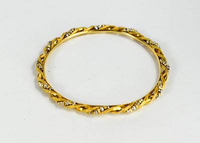 Lot 246 - A gold bangle of beaded twist form, unmarked...