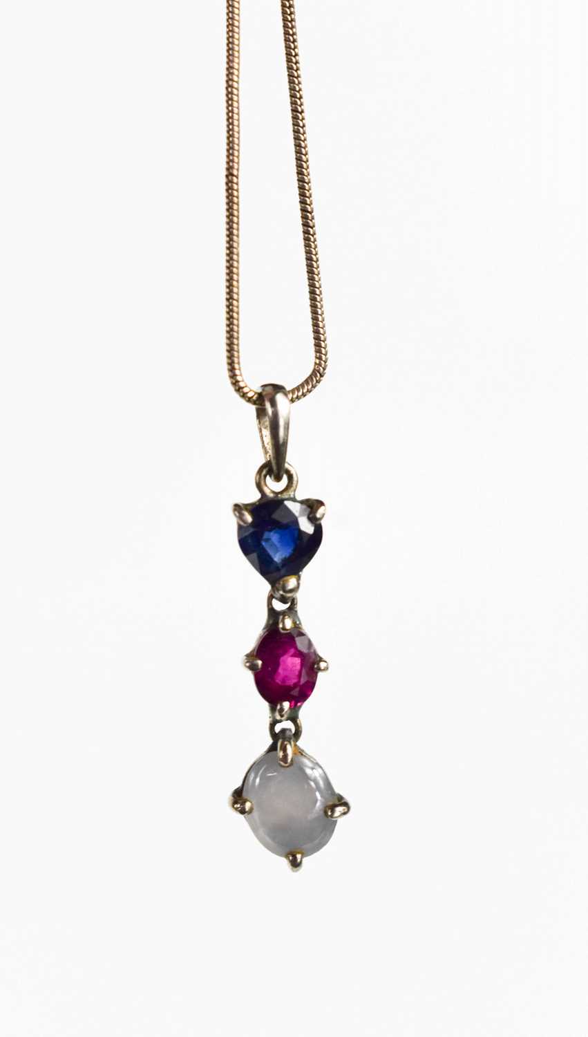 Lot 70 - A silver set moonstone, ruby and sapphire...