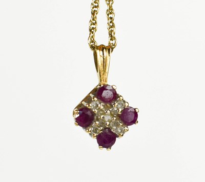 Lot 52 - A 9ct gold, diamond and pink sapphire pendant...