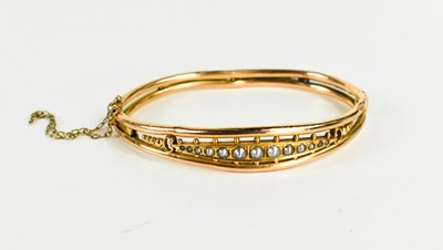 Lot 243 - A Victorian 15ct gold and seed pearl bangle,...