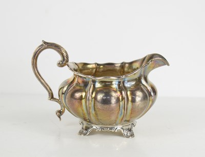 Lot 386 - A Georgian silver sauce boat, the body of...