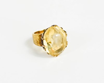 Lot 203 - A gold and citrine ring, the oval cut citrine...