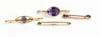 Lot 108 - A gold plated and amethyst brooch, the oval...