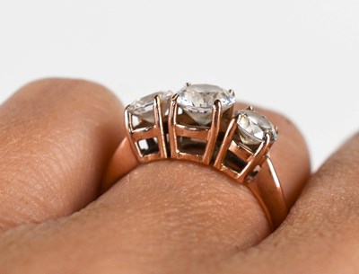 Lot 23 - A 14ct rose gold and cubic zirconia three...
