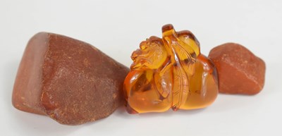 Lot 134 - A Chinese amber pendant / bead, carved in the...