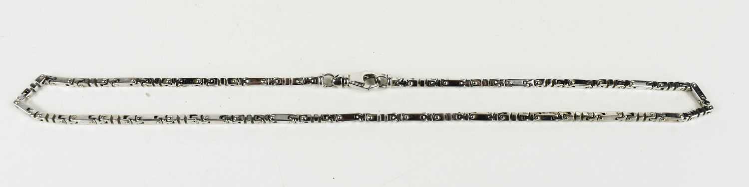 Lot 32 - A 9ct white gold necklace of bar and T-block...