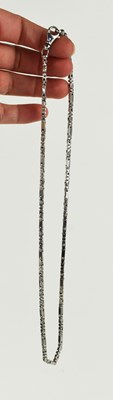 Lot 32 - A 9ct white gold necklace of bar and T-block...
