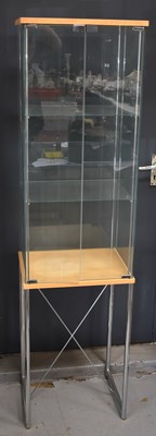 Lot 166a - A modern glass display cabinet on a chrome...