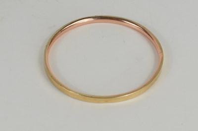 Lot 135 - A 9ct gold bangle, hallmarked for Birmingham...