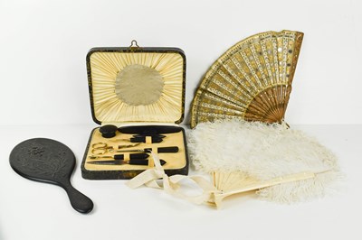 Lot 188 - An ostrich feather fan, with ivorine sticks,...