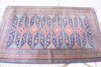 Lot 519 - A Persian wool rug, red ground, with geometric...