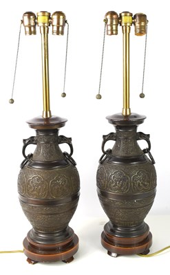 Lot 101 - A pair of Chinese bronze table lamps, 20th...
