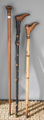 Lot 241 - A group of three walking sticks, comprising a...