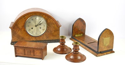 Lot 141 - A 1950s walnut veneered mantle clock, the dial...