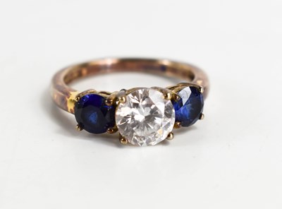 Lot 76 - A silver, sapphire and cubic zirconia three...