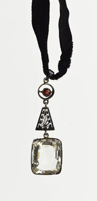 Lot 49 - An Art Deco garnet and paste pendant on velvet...