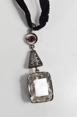 Lot 49 - An Art Deco garnet and paste pendant on velvet...