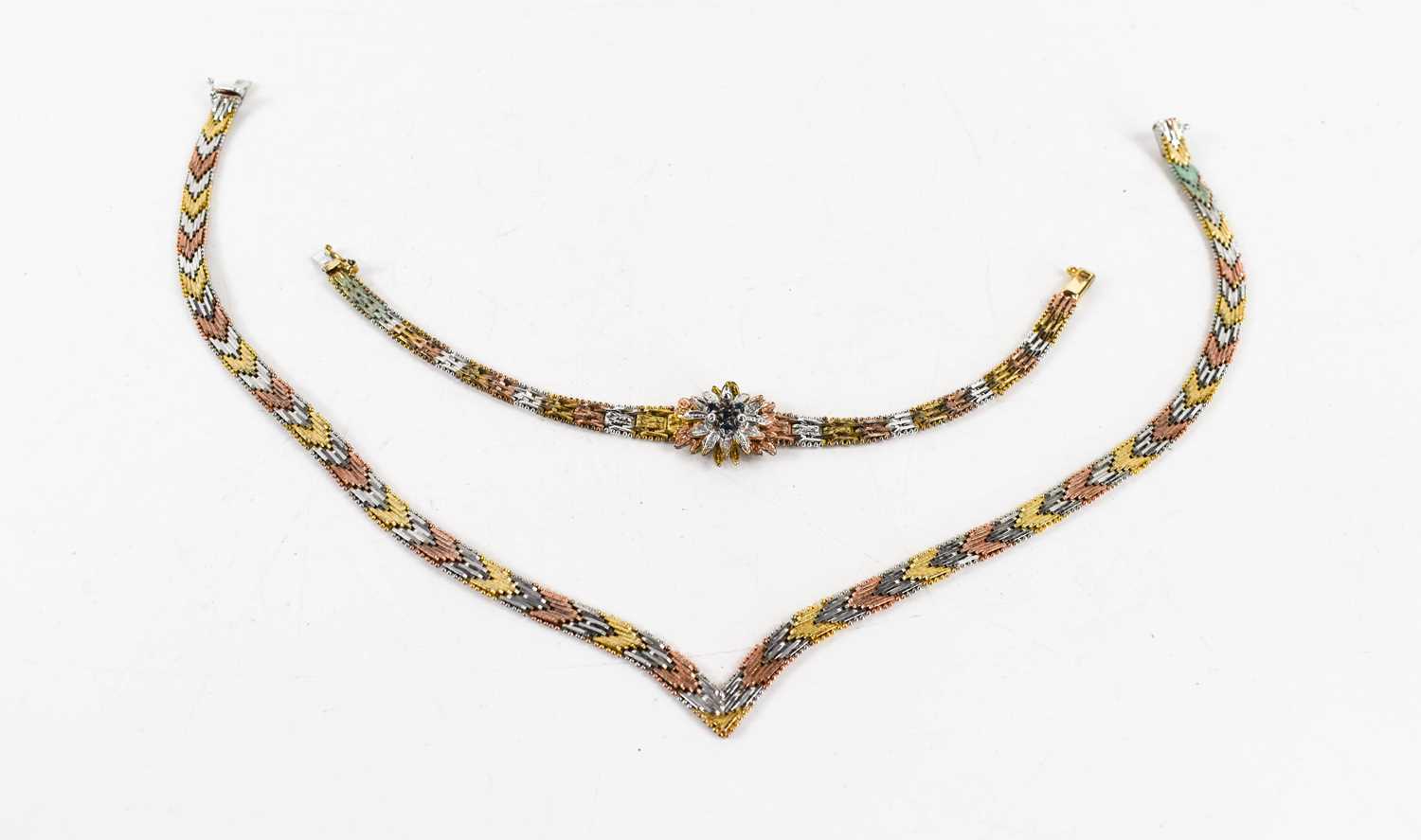Lot 42 - A tri-colour herringbone necklace marked 9...