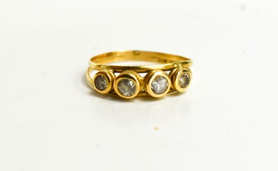 Lot 104 - An 18ct gold and paste four stone ring, size O,...