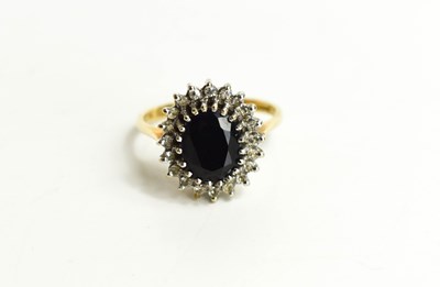 Lot 113 - A 9ct gold, sapphire and diamond ring, the...