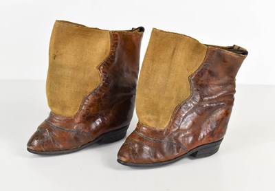 Lot 179 - A pair of unusual leather lotus shoes or boots,...