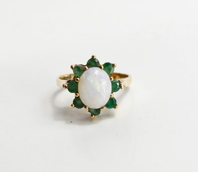 Lot 121 - A 9ct gold, opal and emerald ring, in the form...