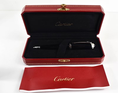 Lot 57 - A Cartier ballpoint pen, black composite body...