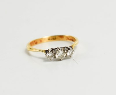 Lot 118 - An 18ct gold and diamond three stone ring, the...