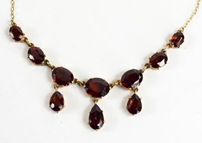 Lot 97 - A 9ct gold and garnet necklace, the front of...