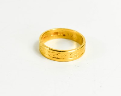 Lot 126 - A 22ct gold ring, engraved with foliate...