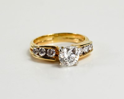 Lot 25 - An 18ct yellow gold and diamond ring by...