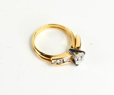 Lot 25 - An 18ct yellow gold and diamond ring by...