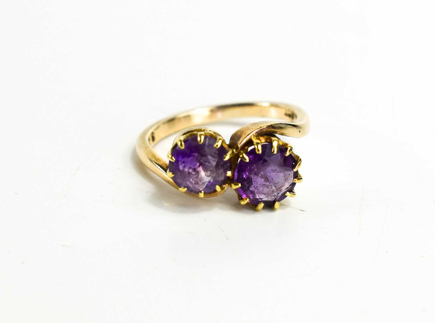 Lot 70 - A 9ct gold and amethyst cross over ring, or...