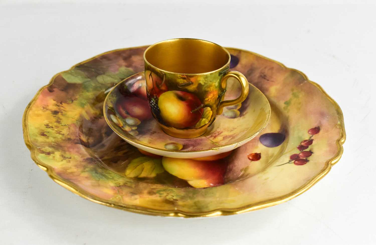 Lot 12 - A Royal Worcester trio painted with fruit, by...