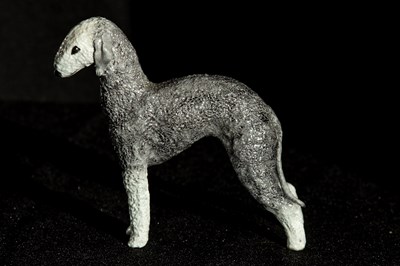 Lot 199 - A finely detailed porcelain Bedlington Terrier,...