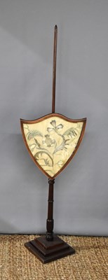 Lot 454 - A 19th century mahogany pole fire screen, the...