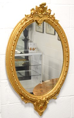 Lot 399 - A giltwood oval wall mirror in the 19th...