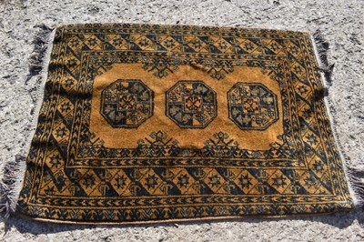 Lot 412 - A small Middle Eastern yellow ground rug with...