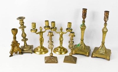 Lot 317 - A group of brass candlesticks, a pair in the...