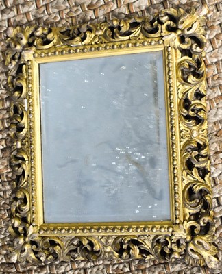 Lot 398 - A 19th century giltwood mirror, carved with...