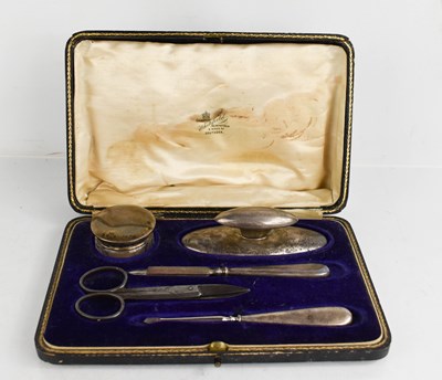 Lot 235 - An Edwardian silver manicure set, Birmingham...